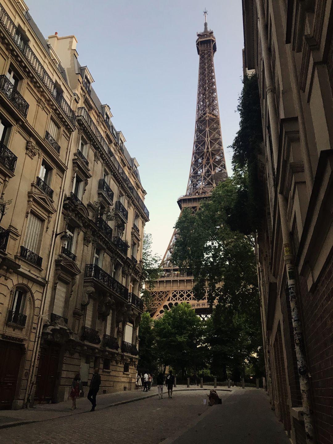 The Eiffel Tower seen from a Parisian street