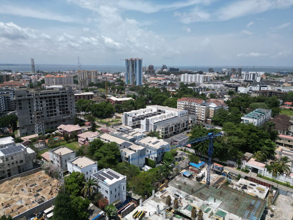 Aerial view of Lagos cityscape with coastal waters on the horizon