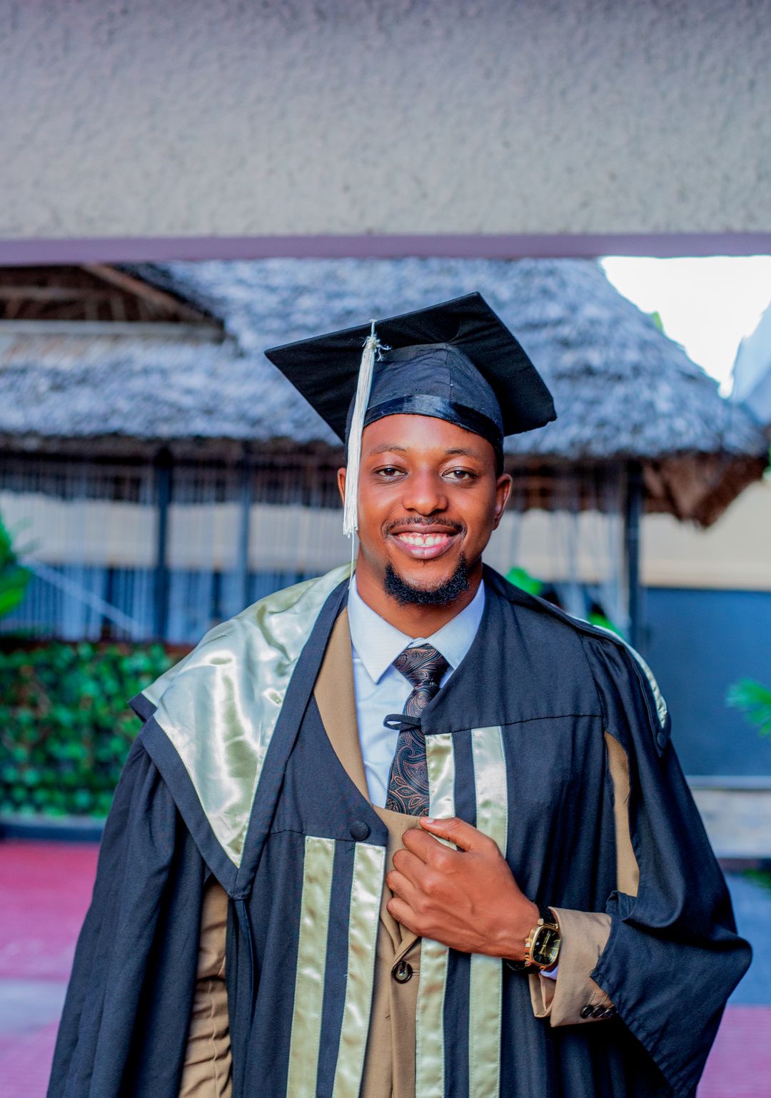 A smiling graduate in cap and gown