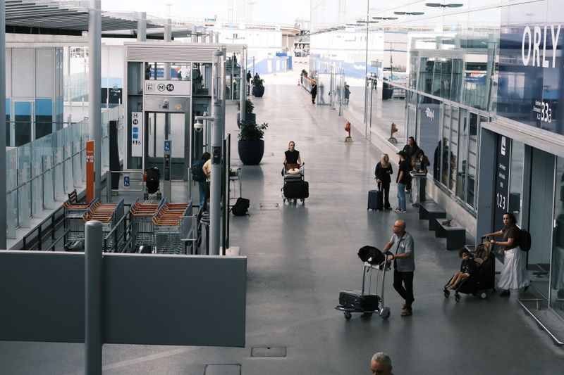 Airport terminal with travelers and luggage